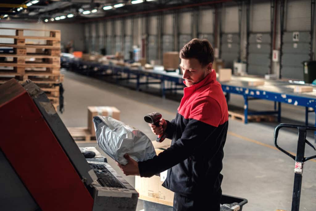 Courier picks up package on a warehouse.